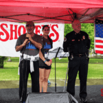 David Davoudpour giving a speech next to a police officer after the run.