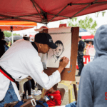 Artist doing a caricature portrait of a runner.