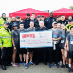 David Davoudpour posing with Metro Nashville Police Department and their gifted $16k check.